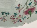 a white plate with a pink flower on it