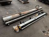several pieces of metal are laying on the floor in a warehouse