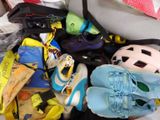 a pile of shoes and other items in a suitcase
