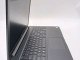 a laptop with a black keyboard sitting on a white surface