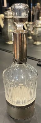 a bottle of perfume sitting on a counter in front of a mirror