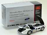 a silver model of a sports car next to a box