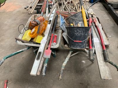 a pile of tools sitting on the ground in the yard