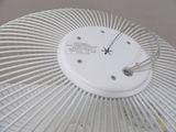 a white fan with a clock on top of it