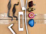 a cardboard box with various tools on it, including a hammer, a wrench, and a ball