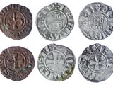 six different types of coins are shown on a white surface
