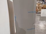 a refrigerator that is sitting on a pallet in a warehouse