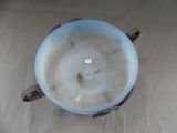 a blue bowl with a handle sitting on a table