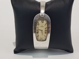 wrist watch sitting on a pillow on a white surface