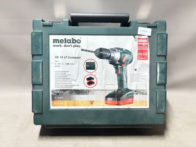 a green box with a black and red tool in it