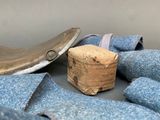 a cork in the middle of a pile of blue jeans