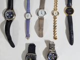 a lot of watches that are sitting on a table