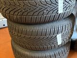 four tires stacked on top of each other on a floor
