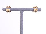 a close up of a pair of earrings on a stand