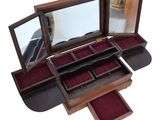 a wooden box with a mirror on top of it