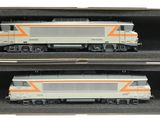 deux trains miniatures posés dans une boîte sur la table