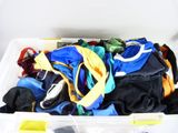 a white container filled with lots of clothes and other items