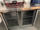 stainless steel counter top with two ovens and a toaster on it