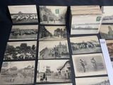 a lot of old black and white pictures on the table