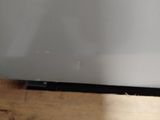 a television sitting on top of a wooden table