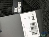 a label on the back of a sweater that says the koople