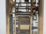 a gold clock that is sitting on a table