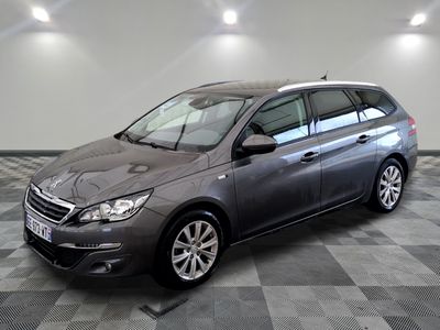 the grey car is parked on a checkered floor in the garage