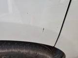 a close up of a tire on a white car