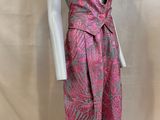 a mannequin wearing a pink and grey patterned suit on a white mannequin