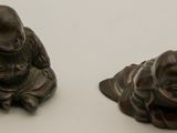 pair of bronze figurines of a man and a woman sitting on a lotus