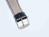 the strap is black and white with a silver buckle on it