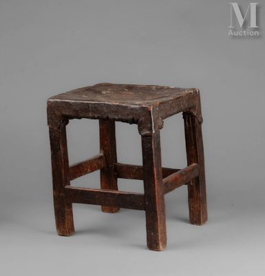 an old wooden stool with a wooden seat on a gray background