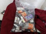 a plastic bag filled with assorted items on a bed