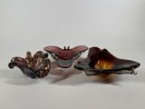 three pieces of glass sitting on top of each other on a white surface