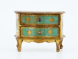 a small chest of drawers on a white surface
