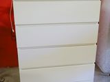 a tv on top of a white dresser in a room