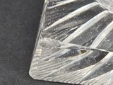 a clear piece of glass on a black surface