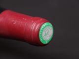 a red wine bottle with a green label on it