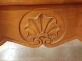 a close up of a wooden table with carvings on it