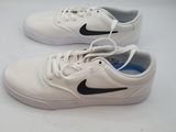 white and black nike sneakers on a white surface