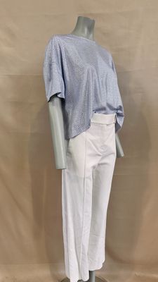 the mannequin is wearing a blue shirt and white pants