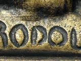 a close up of a bronze statue of a dog
