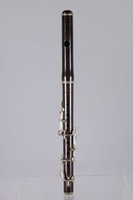 a close up of a clarinet on a table with a white background