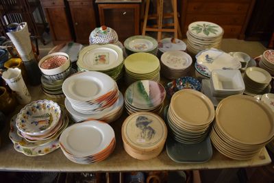 a lot of plates and bowls on the table