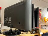 a computer monitor sitting on top of a wooden desk