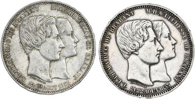 a silver coin with two heads of two women and one man