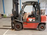 a red forklift truck parked in a warehouse