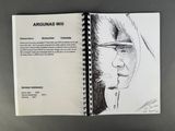 an open sketch book with a drawing of a man in a hoodie