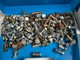 a blue box full of nuts and screws on the floor