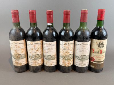 six bottles of wine are lined up in a row on a table